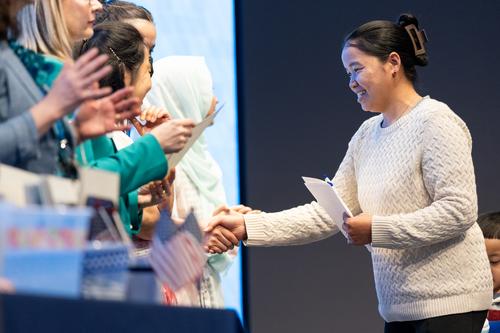 English learners celebration with families shaking hands